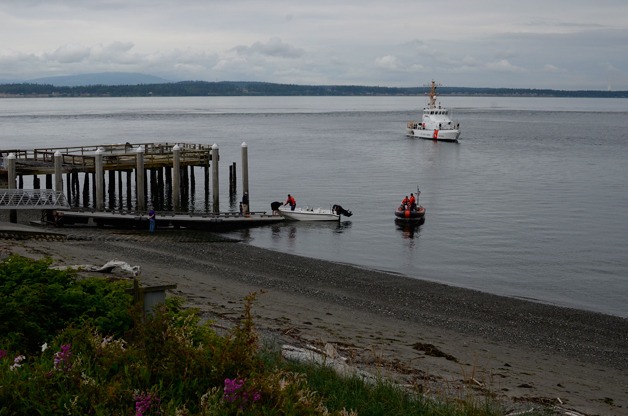 The U.S. Coast Guard brings a 14-foot leisure boat to the dock at Bush Point on Sunday morning. The boat broke free Saturday night because of high winds.