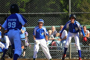 Drew Petty and Carson Filla wait at home plate to celebrate with Nick Young after he blasted a home run against Sedro-Woolley on June 30 at South Whidbey Community Park in Langley. South Whidbey fell 7-6 and was eliminated from the District 11 11/12-year-old All-Stars tournament.