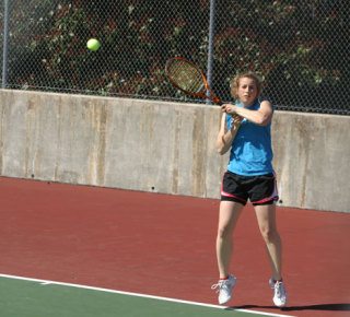 Falcon Natalie Wheeler returns a serve from Eagle opponent Nikki Scheck on Monday.