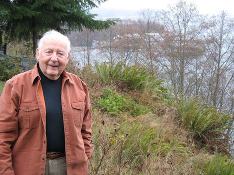 Rolf Seitle in the back yard of his Langley home overlooking the revitalized South Whidbey Marina. After more than six years