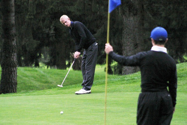 Harrison Price putts for par on the seventh hole on the first day of the District 1 boys golf tournament. Price finished the round two over par.