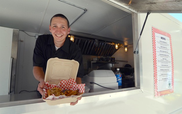 Joe Wierzbowski displays a freshly cooked lunch from his food truck in Langley Thursday. The new business has come under fire from neighboring buisness owners and members of the city council.