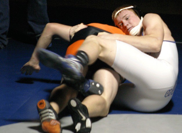 Falcon wrestler Montana Johnson rolls Mike Poyner onto his shoulders during the 182-pound match.