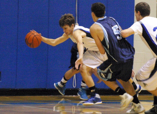 Falcon junior Taylor Simmons scrambles for a loose ball against Turk junior Steven Branham.