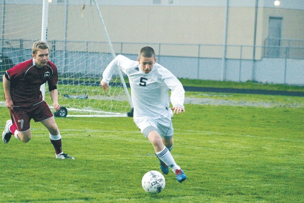 Cameron Coupe pushes the ball upfield and away from South Whidbey’s goal as Cedarcrest senior Zach Wilhelm chases. South Whidbey lost 1-0 and dropped its record to 2-3 in Cascade Conference games.