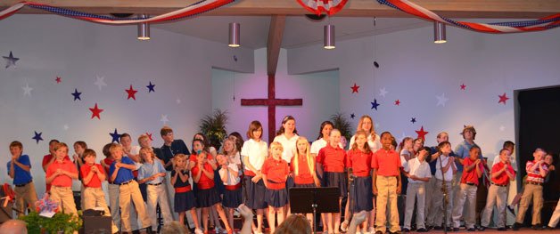 Wellington Day School students gather as part of their patriotic performance June 6 at the Island Church.