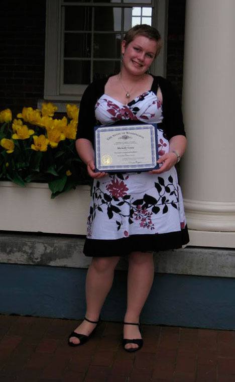 Michelle Casey shows her award for outstanding volunteer service in support of her peers and school.