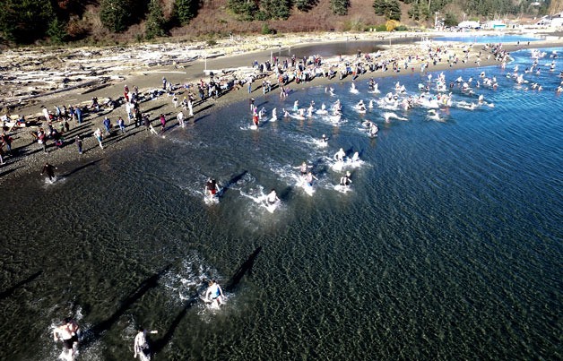 Participants in the Polar Bear Plunge at Double Bluff Beach Park brave the chilly waters to usher in a new year. This shot was captured with a drone.