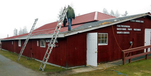 RainShield employees inspect the last section of the Burrier building agricultural shed prior to installing the roofing.