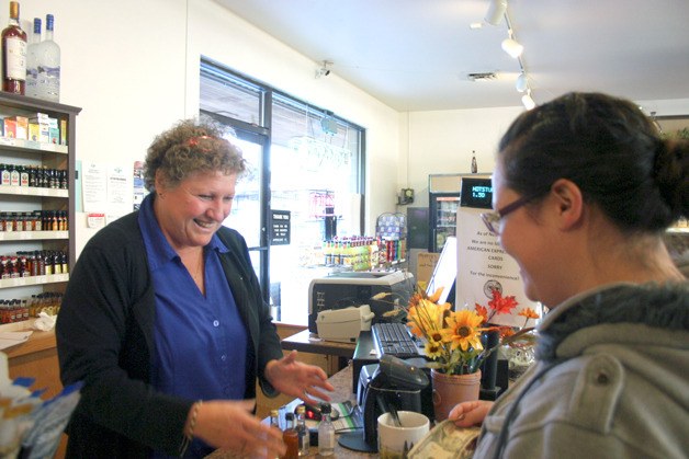 Nickole Martinez of Clinton buys a few 50 milliliter bottles from Clinton Liquor Store owner Jan Neil. The vast selection and mini bottles