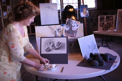 Stephanie Schuemann preps her display at Crockett Barn during the Whidbey Open Studio Tour in September.