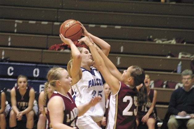 Falcon junior Hayley Newman gets fouled by Cougar senior Ashlie Jensen during South Whidbey’s 60-52 overtime victory. Newman scored 14 points