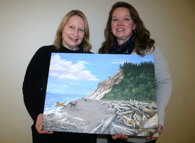 Lydia Johnson holds her painting with her friend