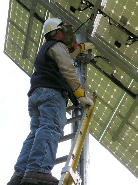 A Puget Sound Energy service technician installs the metering equipment to allow the solar array to be connected to the utility grid at Marguerite Brons Memorial Park.