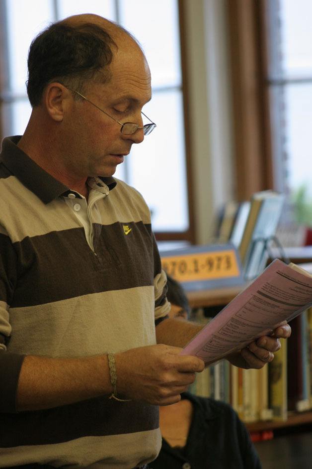 Science teacher Jay Freundlich reads a statement from LMS staff opposing an early start to the consolidation effort.