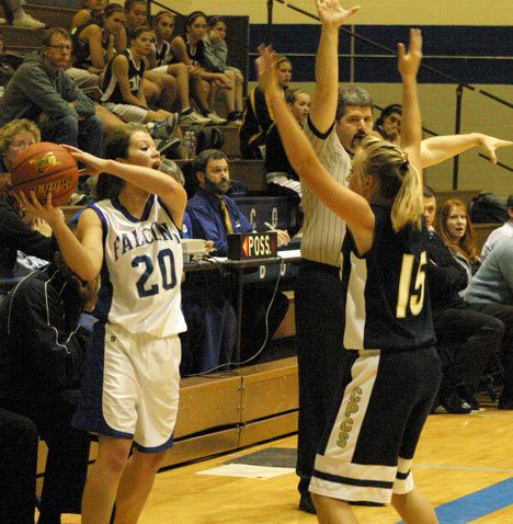 Falcon Reilly O'Sullivan yells to her teammates over the outstretched hands of a Cedar park Christian player Tuesday.