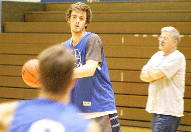 Falcon senior forward Zach Comfort looks for a high-low post pass during a recent practice as assistant coach Ed Baran watches.