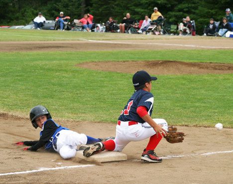 Little Leaguer Conor Antich slides safely into third base Monday as All Star action gets under way at South Whidbey Community Park. It was a tight game — the teams were tied in the fifth inning — and the boys lost 3-2 to South Skagit.