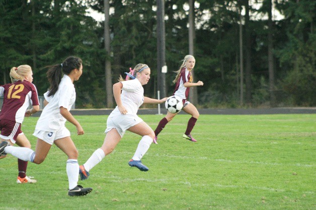 Olivia Bolding chases down a pass from teammate Lindsey Grimm during the game against Lakewood on Tuesday night.