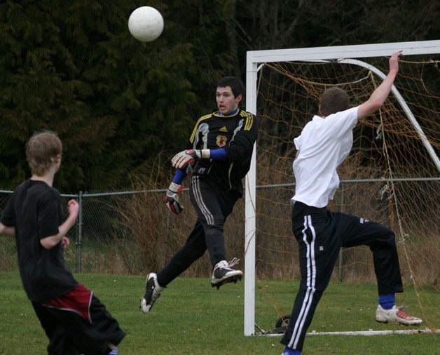 Falcon co-captain and goalkeeper TJ Russell deflects a shot on goal during scrimmage. Russell