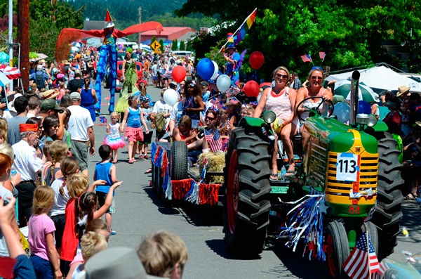 A 1951 Oliver Row crop tractor owned by the Gabelein family makes its way down Maxwelton Road during the Fourth of July Independence Day parade.