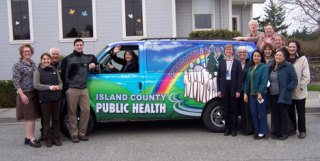 Employees of the Island County Public Health Department gather around their new community-health van.