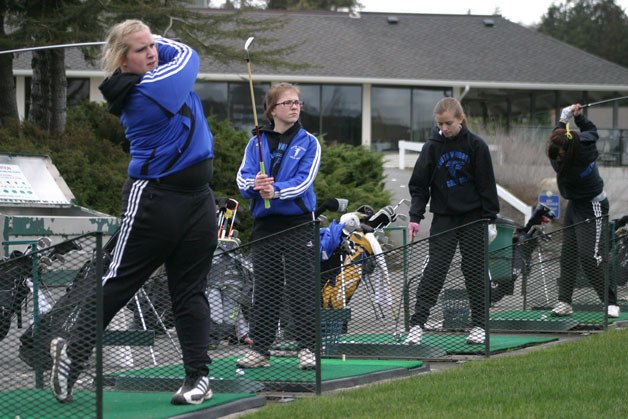 Jenna Kaik tees off at Useless Bay Golf and Country Club during practice. Behind her