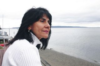 Laura Valente looks out at Saratoga Passage from her deck at Whidbey Shores. She fears that ghost-shrimp harvesters will keep the gray whales away.