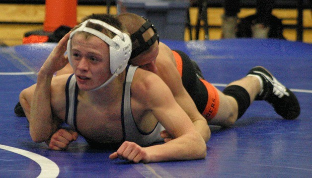 Jeff Kunellis looks to his coaches for advice as he reverses out of his opponent’s grip. Kunellis lost his first match