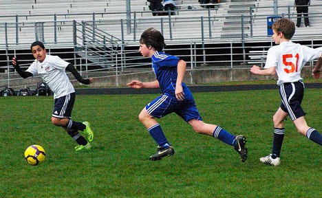 Revolution soccer player Bryce Auburn pursues a ball during his team’s 5-0 victory over the Synergy team from Auburn.