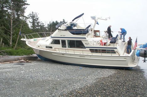 A large boat sits on the shore near Columbia Beach on Tuesday after the crew lost control of the vessel.