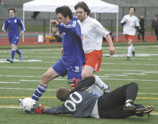 Noah Moeller splits Granite Falls defender Marshall Zenk and goalie Joey Best. Moeller scored his third and final goal of the night on the play to end South Whidbey’s four-game losing streak.