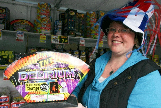 Gena Kraha holds up the 'Delirium' shell firework at the Kiwanis TNT fireworks stand on Ken's Korner. The fireworks stand is open 11 a.m. to 8 p.m. until July 5.