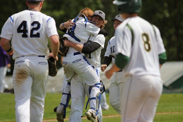 South Whidbey players swarm closing pitcher Charlie Patterson after he struck out the final three Overlake batters in the 14th inning of the first-round 1A bi-district playoff game May 9 in Bellingham.