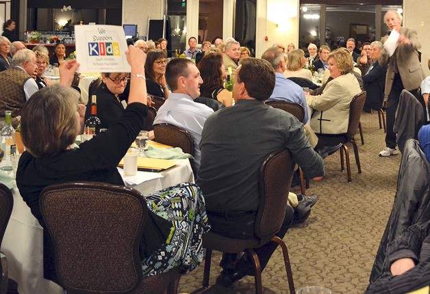 Jim Freeman announces Susie Richards winning bid during the South Whidbey Schools Foundation gala dinner and live auction April 26 at Useless Bay Golf & Country Club.