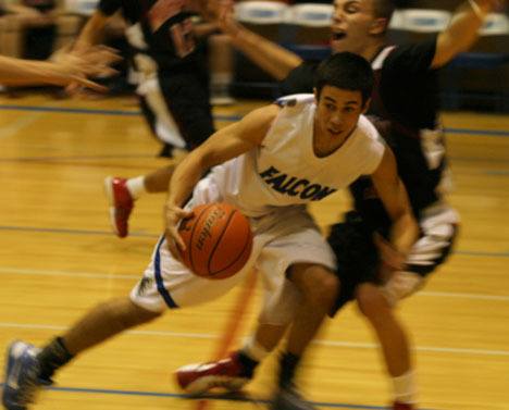 Falcon Andy Bennett charges past Wildcat players in the third quarter of Friday’s 63-62 win over arch-rival Archbishop Murphy. The teams are tied for second place in the Cascade Conference standings.