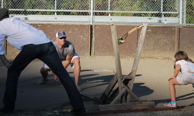 Eric Patrin of Clinton launches a piece of zucchini from a giant slingshot at Dan Porter Memorial Park in Clinton as part of the Clinton Town Picnic festivities.