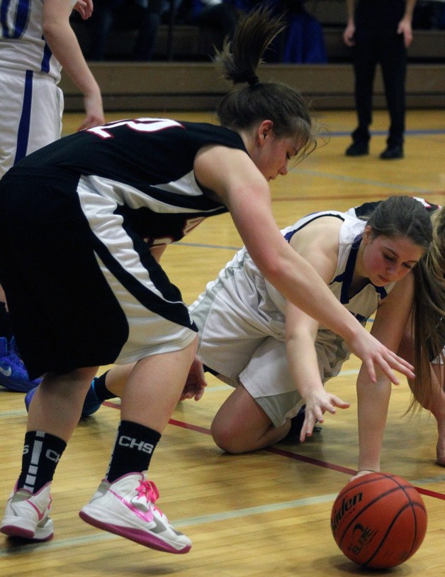 Falcon junior Abby Hodson hits the court for a loose ball as Coupeville’s Maddi Strasburg reaches for it. South Whidbey lost a two-point halftime lead as the Wolves rallied to win 48-38 and secure a 1A playoff spot.