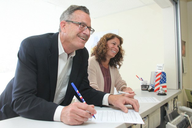 Husband and wife Tim Callison and Robin Black file paperwork for the 2015 elections at the Island County election office in Coupeville on May 11