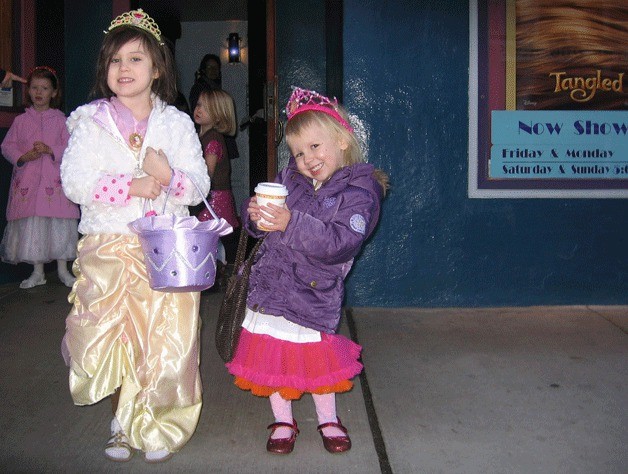 Alina Allan and Ava Marx pose in front of the Clyde Theatre in Langley.