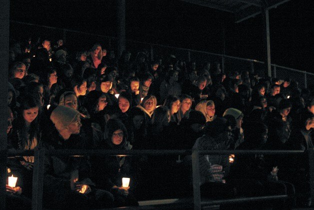 Mourners gather at the grandstand at South Whidbey High School on Saturday for a candlelight vigil for three victims of a fatal car crash.