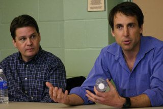 Andy Wappler listens as Michael Payne speaks at the forum.