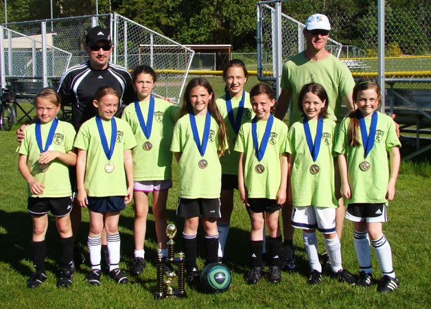 The Green Hornets pose for a picture with their U-10 girls soccer division title medals after winning Soccerfest. Pictured from left to right: Lila McCleary