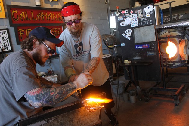 Patrick Forrestal and Brian Iverson work on blown-glass rockfish at Callahan’s Firehouse in Langley on Thursday.