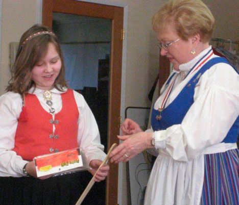 Clara Larsen of the Young Skandia Dansers presents Salli Schonning of Ester Moe Lodge No. 39 a thank-you gift for leading a class for the dancers on how to make lefse.