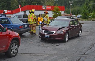 South Whidbey Fire/EMS emergency responders and an Island County Sheriff’s deputy assess damage after a four-car crash on Highway 525 near Ken’s Korner. None of the drivers required medical transport.