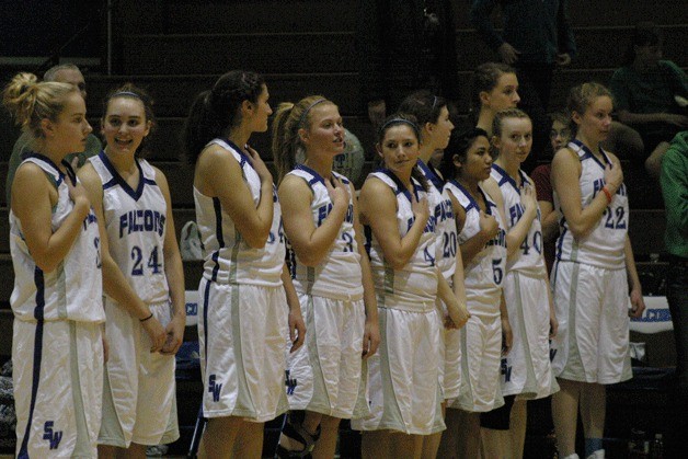 South Whidbey’s varsity girls basketball team recites the Pledge of Allegiance before hosting the Sultan Turks. The Falcons finished 1-13 in Cascade Conference play.