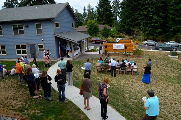 Attendees of a grand opening ceremony for Sunny View Village in Freeland listen as Teri Anania