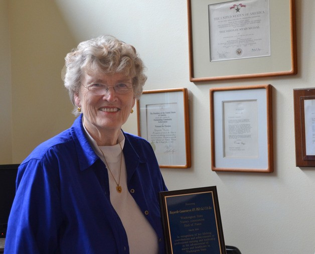 Grethe Cammermeyer stands in her office with a recent award inducting her into the Washington State Nurses Association Hall of Fame.