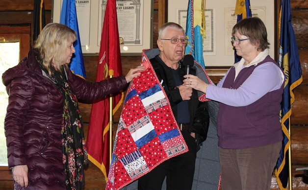 Russell and Barbara Nichols receive a quilt in honor of their son